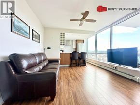 Vancouver apartment for rent - A living room with a brown leather couch and a flat screen TV.