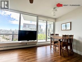 Vancouver apartment for rent - A living room with a television and a table with chairs.