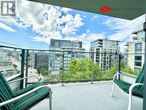 Vancouver apartment for rent - A balcony with green chairs and a view of the city.