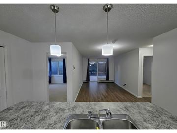 Edmonton apartment for rent - A kitchen with granite countertops and a double sink.