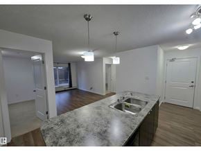 Edmonton apartment for rent - A kitchen with a granite countertop and a sink.