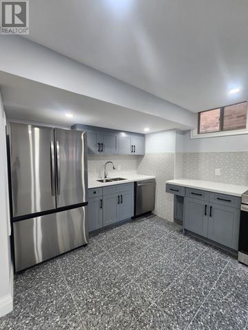 Innisfil (Alcona) apartment for rent - A kitchen with a stainless steel refrigerator and a countertop.