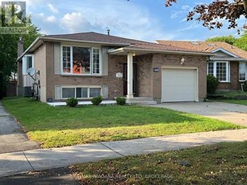 Niagara Falls (West Wood) apartment for rent - A house with a brown brick exterior and a white garage door.