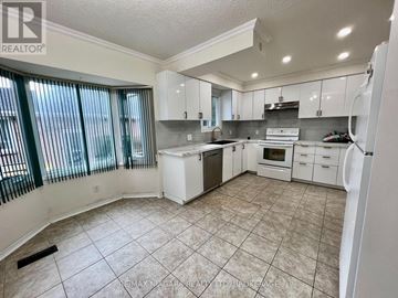 Niagara Falls (West Wood) apartment for rent - A kitchen with white cabinets and a tile floor.