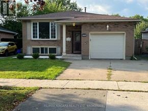 Niagara Falls (West Wood) apartment for rent - A house with a garage and a car parked in front.