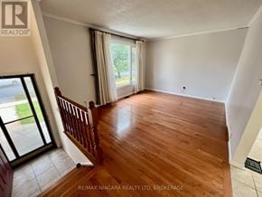 Niagara Falls (West Wood) apartment for rent - A room with wooden flooring and a sliding glass door.