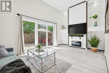 Hamilton (Red Hill) townhouse for rent - A living room with a glass coffee table and a grey sofa.