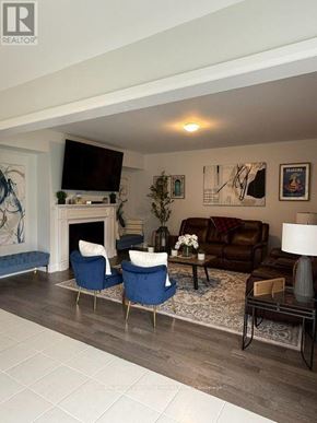 Woodstock (Woodstock - North) apartment for rent - A living room with a fireplace, two chairs, a couch, and a television.