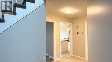 London North (North S) apartment for rent - A hallway with a staircase on the left and a kitchen area on the right.