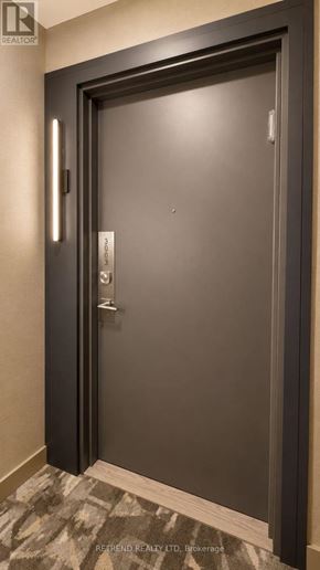 Toronto (Willowdale West) condo for rent - A modern door with a handle and a keypad for entry.