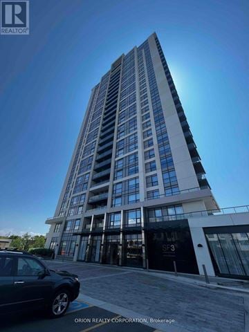 Pickering (Bay Ridges) condo for rent - A tall building with a car parked in front of it.