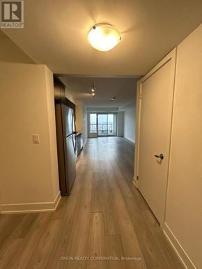Pickering (Bay Ridges) condo for rent - A long hallway with wood floors and white walls.