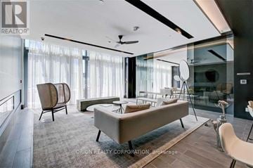 Pickering (Bay Ridges) condo for rent - A modern living room with a large sectional sofa and a glass table.