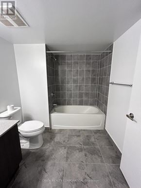 Pickering (Bay Ridges) condo for rent - A bathroom with a toilet, tub, and sink.