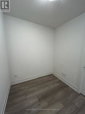 Pickering (Bay Ridges) condo for rent - A room with wooden flooring and white walls.