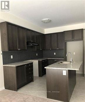 Niagara Falls (Brown) apartment for rent - A kitchen with dark brown cabinets and a granite countertop.