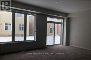 Niagara Falls (Brown) apartment for rent - A room with a large window overlooking a snowy street.