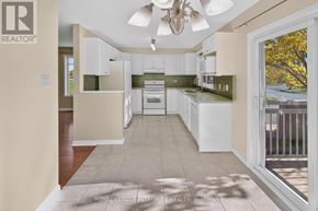 Ottawa townhouse for rent - A well-lit kitchen with white cabinets and a ceiling fan.