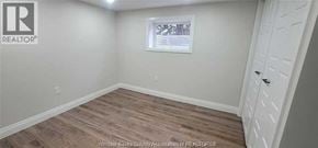 Windsor apartment for rent - A room with a white door and a window with white blinds.