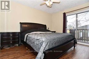 Ajax (South East) apartment for rent - A bedroom with a large bed and a ceiling fan.