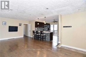 Ajax (South East) apartment for rent - A spacious living room with a dining area and a kitchen in the background.