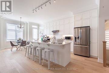 Markham apartment for rent - A modern kitchen with white cabinets and a large island.