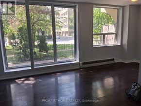 Toronto (Annex) multi-family for rent - A room with a view of a street through a window.