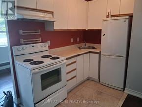 Toronto (Annex) multi-family for rent - A kitchen with a stove, sink, and refrigerator.