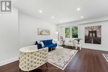 Toronto (Malvern) apartment for rent - A living room with a white sofa and a white wicker chair.