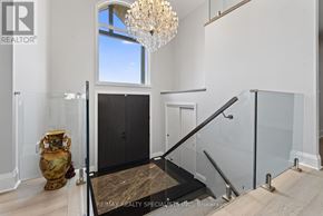 Cramahe apartment for rent - A room with a chandelier, a vase, and a staircase.