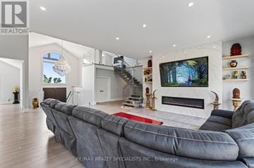 Cramahe apartment for rent - A modern living room with a grey sofa and a fireplace.