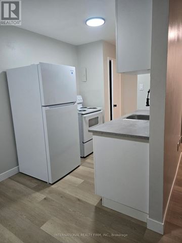 St. Thomas multi-family for rent - A white refrigerator and a white countertop in a kitchen.