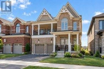 Barrie multi-family for rent - A large, multi-level house with a brick facade and a covered front porch.