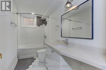 Toronto (Weston) apartment for rent - A white bathroom with a toilet, sink, and bathtub.