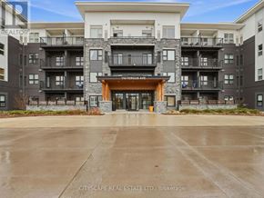 Kitchener condo for rent - The image shows a multi-story residential building with a large entrance and balconies.