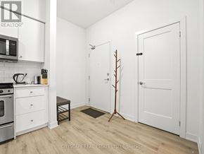 Kitchener condo for rent - A small, white kitchen with a microwave and oven.