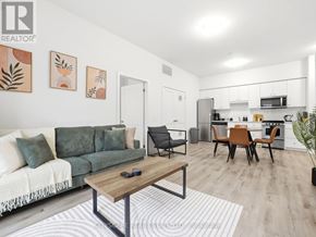 Kitchener condo for rent - A modern living room with a green couch and a wooden coffee table.
