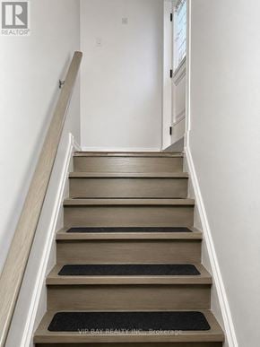 Georgina (Keswick North) apartment for rent - A set of stairs with a black mat on the bottom step.