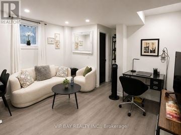 Georgina (Keswick North) apartment for rent - A living room with a white couch and a black chair.