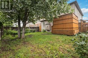 London North (North B) apartment for rent - A backyard with a wooden fence and a tree.