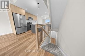 Ottawa townhouse for rent - A kitchen with a refrigerator, microwave, and oven.