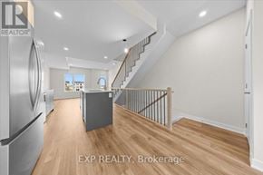 Ottawa townhouse for rent - A kitchen with a refrigerator and a staircase.