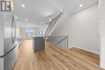 Ottawa townhouse for rent - A kitchen with a refrigerator and a staircase.