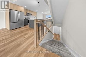 Ottawa townhouse for rent - A kitchen with a refrigerator, stove, and microwave.