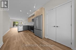 Ottawa townhouse for rent - A kitchen with white cabinets and a wooden island.