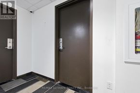 Waterloo condo for rent - A brown door with a white sign on it in a room.