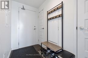 Waterloo condo for rent - A white door with a black handle and a black mat on the floor.