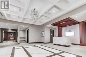 Hamilton (Central) condo for rent - A spacious lobby with a reception desk and a television mounted on the wall.