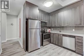 Hamilton (Central) condo for rent - A kitchen with a refrigerator, microwave, oven, and sink.