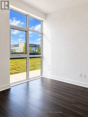 Hamilton (Waterdown) condo for rent - A room with a large window and sliding glass doors.